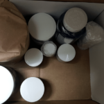 Various nootropic jars in a shipment package with one jar being wrapped in brown paper